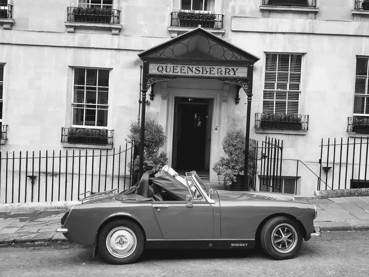 A convertible car parked in front of The Queensberry Hotel in Bath