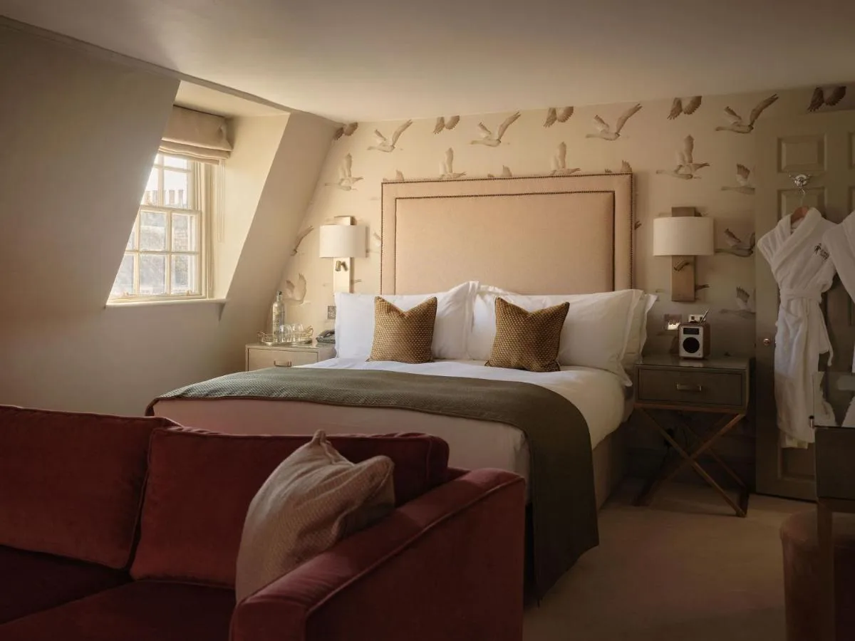A bedroom with a large bed and a couch at The Queensberry Hotel in Bath